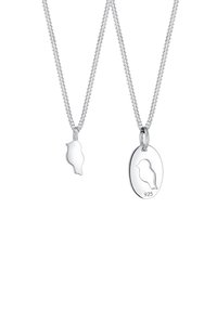 Ensemble de bijoux en argent comprenant un pendentif en forme d'oiseau et un pendentif rond avec un oiseau gravé, présentés sur des chaînes en argent fines.