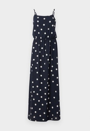 Tamsiai mėlynas maxi suknelė su baltais taškais. Pasižymi plonomis reguliuojamomis petnešomis, elastingu juosmeniu ir laisvu siluetu. Lygus audinio paviršius.