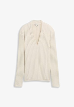 Crème ribbel langsl sleeve top met een V-hals. Kenmerkt een textuurstof en rechte zoom. Eenvoudig ontwerp, geschikt voor het layeren.