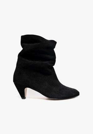 Black suede ankle boots with a slouch design, pointed toe, and 2-inch cone heel. Smooth texture with a minimalist silhouette.