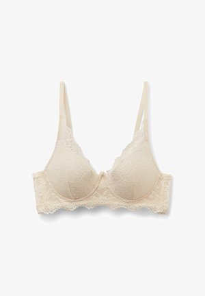 Spitzen-BH in hellbeige mit gepolsterten Körbchen, dünnen verstellbaren Trägern und floralen Musterdetails, mit gezackten Spitzenrändern.