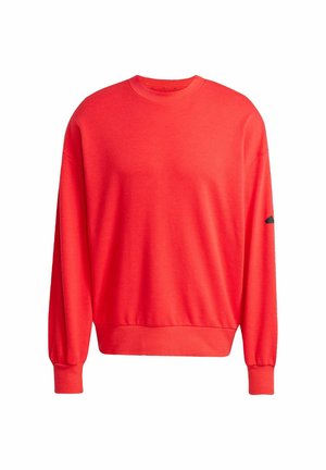 Roter Sweatshirt aus Baumwolle, mit Rundhalsausschnitt, langen Ärmeln mit gerippten Bündchen und geripptem Saum. Mit einem schwarzen Akzent am Ärmel.