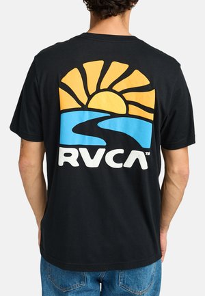 Black cotton T-shirt with a large graphic on the back, depicting a sunrise and a river in yellow, blue, and white. Brand logo "RVCA" included.
