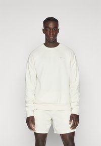 Nike Performance PRIMARY CREW - Mikina - pale ivory