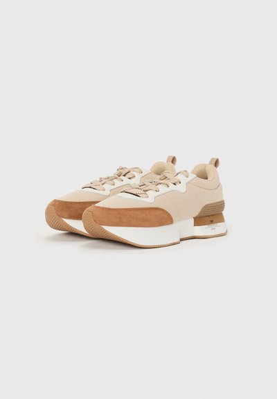 Beige and brown sneakers with a mix of smooth and suede textures. Chunky white midsole and brown rubber outsole, featuring lace-up design.
