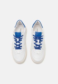 White leather sneakers with blue accents and laces, featuring perforated details on the toe and a blue logo on the heel tab.