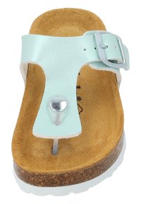 Mintgrön syntetiska ovandel med en silverfärgad spänne, korksoffor och vit gummisula. Har en tåpost med en dekorativ knapp.