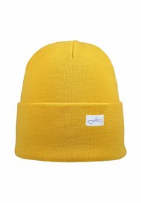Yellow knit beanie with a rolled cuff, made of soft fabric. Features a small white label with blue logo detailing on the front.
