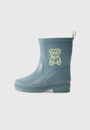 Botte de pluie en caoutchouc bleue avec une semelle texturée, présentant un motif d'ours jaune clair sur le côté et une poignée à l'arrière.