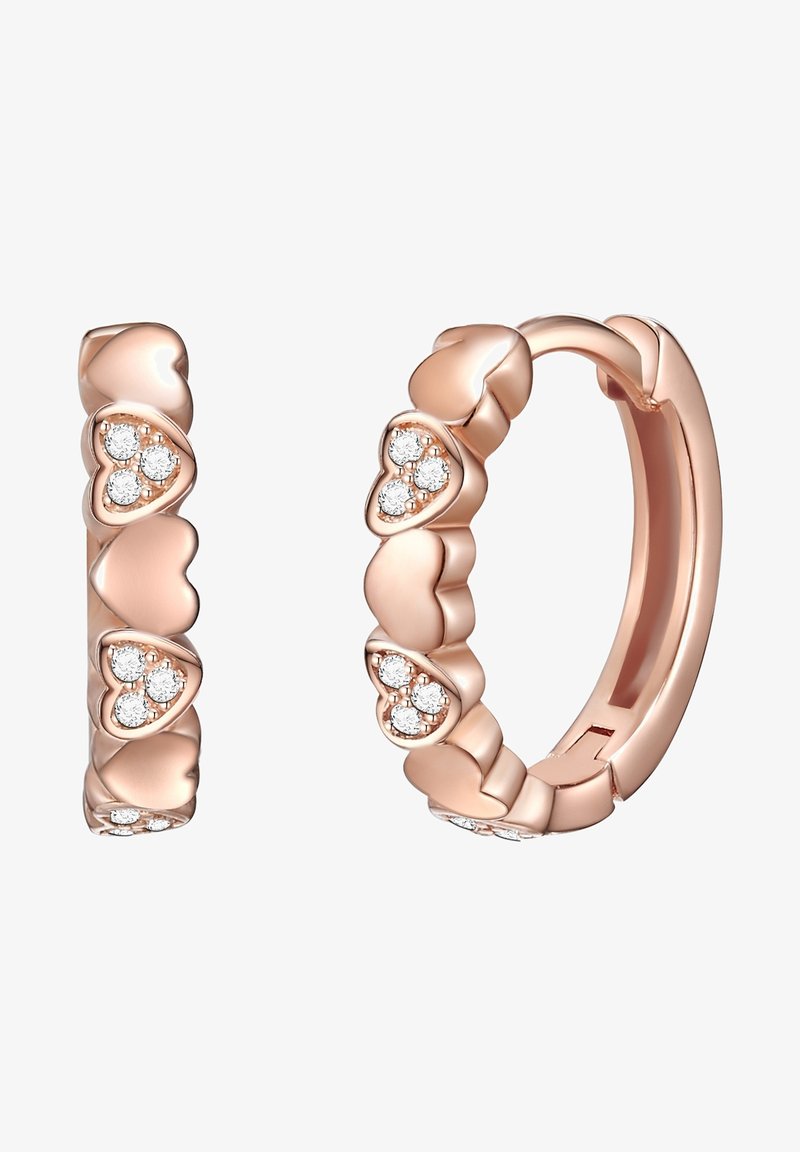 Rozā zelta auskari ar riņķiem, kuros ir sirds formas akcenti, katrā sirdī iekļauti trīs mazi, apaļi dimanti. Gluda, pulēta virsma.