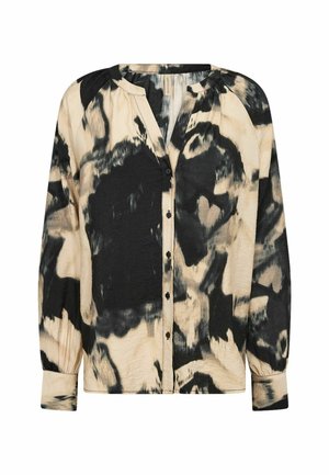 Cream and black button-up blouse with a tie-dye pattern, long sleeves, and a round neckline, featuring subtle pleating at the shoulders.