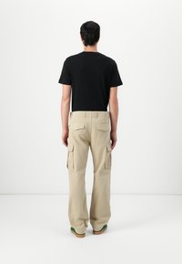 Tommy Jeans OTIS HERRINGBONE PANTS - Cargo trousers - silt