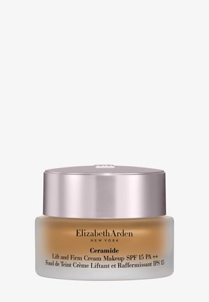 Crème de maquillage Elizabeth Arden Ceramide Lift and Firm avec SPF 15 dans un pot en verre givré avec un couvercle argenté.