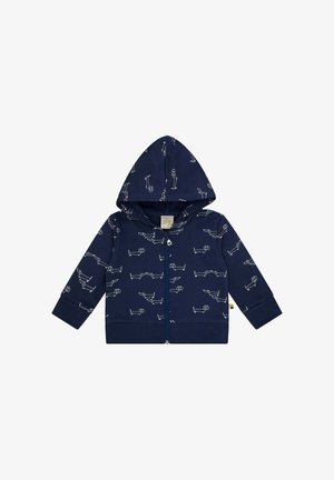 Marineblauwe rits hoodie gemaakt van zacht materiaal, met witte illustraties van honden. Inclusief een gevoerde capuchon en geribde manchetten.