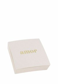 Scatola quadrata, rosa pallido con angoli arrotondati, caratterizzata dalla parola "amor" in carattere dorato sulla superficie superiore. Texture liscia, design minimale.