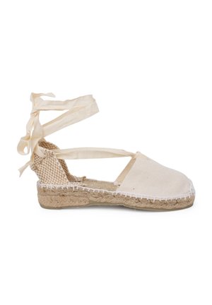 Espadrilles de lien cruzado en lienzo blanco con suela de yute trenzado, presentando un diseño plano. Detalles de costura a lo largo del borde.