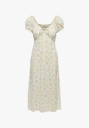 Robe midi crème avec manches courtes bouffantes, encolure dégagée, détail noué et petit motif floral bleu.