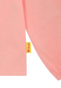 Lichtroze katoenen t-shirt met korte mouwen, voorzien van een gele label met een afbeelding van een personage en de merknaam op de zijnaad.