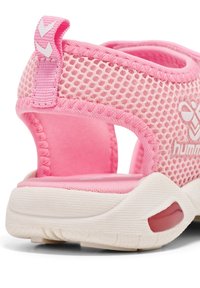 Rosa nät-sandal med en dämpad innersula, uttalad hälstöd och en vit gummisula med en röd accent på sidan.
