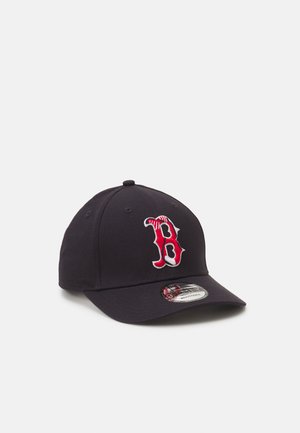 Navy baseball cap with a red and white "B" logo on the front. Features a curved visor and six ventilation holes. Adjustable strap at the back.