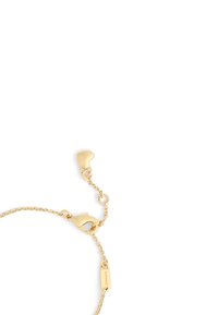 Gul länkarmband med en kräftklaff, förlängda länkar och en liten tagg med "COACH" ingraverad. Slät yta med polerad finish.