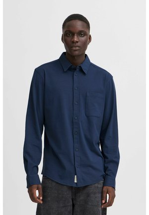 Navy button-up shirt with a single chest pocket, long sleeves, and a smooth texture. Standard collar and a slightly curved hem.