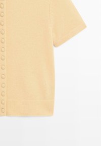 Short-sleeve, light yellow knit top featuring a button-down front, ribbed hem, and textured fabric with vertical lines.