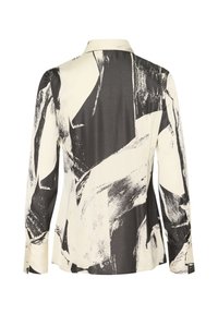 Blouse à manches longues avec motif abstrait en coups de pinceau noir et blanc, poignets boutonnés et col classique, vue de dos.