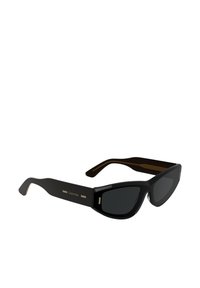Black sunglasses with a sleek, angular design. Dark lenses and gold accents on arms featuring a subtle striped texture. Brand logo displayed.