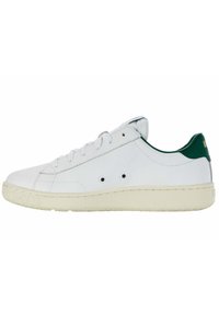 Sneaker bianca con accento verde sul tallone, tomaia in pelle liscia, punta rotonda, lacci sulla parte anteriore, suola in gomma texturizzata e dettagli di design minimalisti.