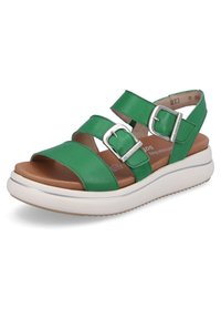 Sandales en cuir vert avec deux brides réglables, boucles argentées, et une semelle plateforme blanche avec une semelle intérieure marron texturée.