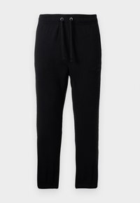 Pantaloni de trening negri din material moale, cu un tiv elastic și șnururi, picioare conice și manșete cu țesătură în relief.