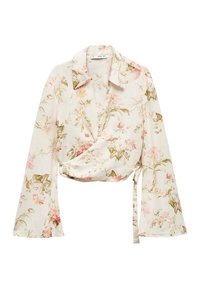 Blouse à manches longues de couleur crème avec des motifs floraux, dotée de larges poignets, d'un col et d'un lien à la taille, présentant des motifs de fleurs roses et vertes.