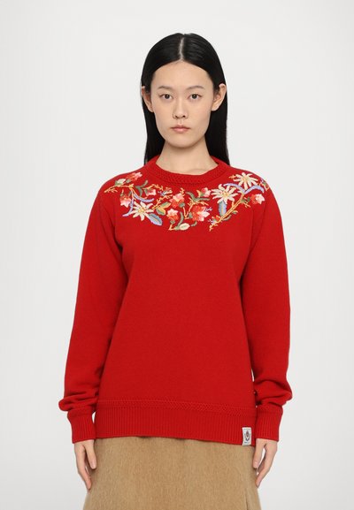 Red knitted sweater with long sleeves, featuring colorful floral embroidery on the front and ribbed cuffs and hem. Includes a logo tag.