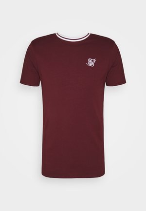 Burgundy T-shirt made of cotton. Features a ribbed crew neck with white accents and a white embroidered logo on the upper left chest.