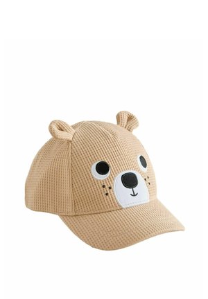 Béžová čiapka s wafflovým vzorom a medvedím obličejom, čierno-bielymi očami, čiernym nosom, usmievajúcimi sa ústami a malými látkovými uškami na vrchu.