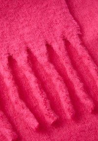 Fleecehandsker i lys pink med et tekstureret design og forlængede, ribbede fingre for forbedret greb og varme.