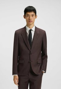 Maroon suit with a notched lapel, single-breasted design, two buttons, and two side pockets. Worn over a white shirt and black tie. Smooth texture.