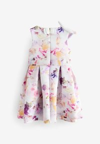 Robe florale aux couleurs pastel, avec une jupe plissée, des détails de bretelles et un nœud dans le dos. Fabriquée en tissu léger.