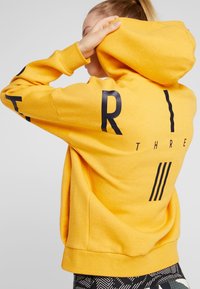 adidas Performance Felpa con zip - gold-coloured