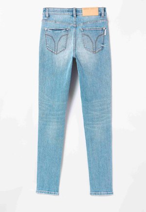Light blue skinny jeans with a mid-rise waist, five pockets, and a leather patch on the back waistband featuring "MISS SIXTY" branding.