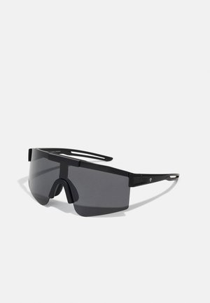 Óculos de sol oversized pretos com uma armação de plástico robusto, design envolvente e lentes escuras, apresentando uma ponte de nariz e poucos detalhes laterais.