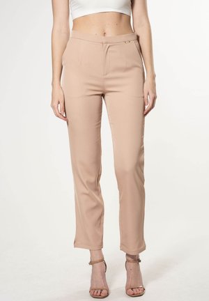Beige tailored trousers with a slim fit, flat front, and subtle gold accent on the waistband. Smooth texture, ankle-length, crease detailing.