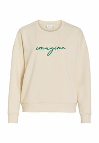 Kremfarget genser med rund hals, oversized passform og grønn brodert tekst "imagine" på fronten. Mykt bomullsblandingsmateriale.