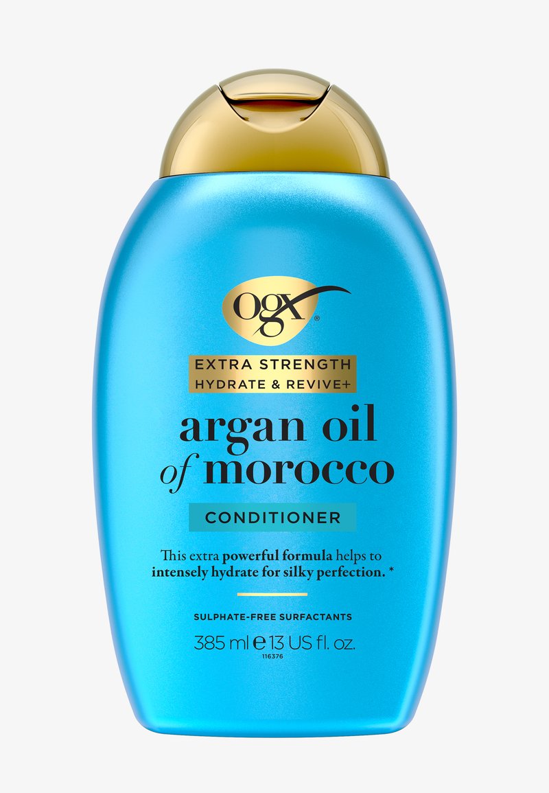 Bouteille bleue de l'après-shampoing OGX Extra Strength Hydrate & Revive Argan Oil of Morocco avec bouchon flip-top doré.