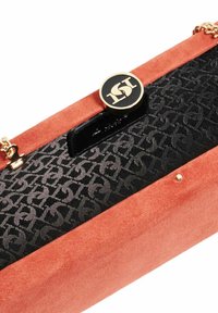 Orange suede clutch with a gold logo accent. Interior features a black patterned fabric, with a secure clasp closure and gold hardware.