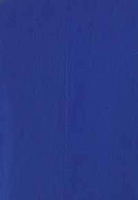 Tissu bleu uni avec une texture lisse. Présente une coutume droite qui descend verticalement au centre. Coloration uniforme partout.