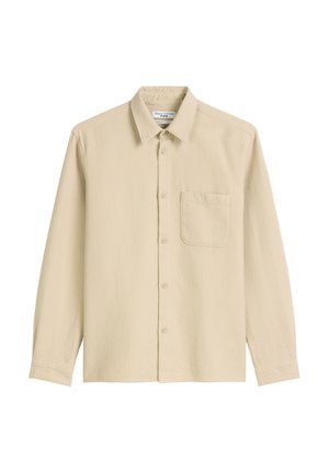Beige langlijfshirt met lange mouwen van textuurstof, voorzien van een kraaghals, knopen aan de voorkant en een borstzakje.