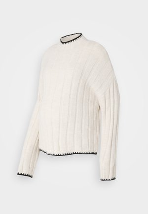 Off-white ribbed sweater with a high neckline, featuring black trim accents at the collar and hem, made from textured fabric.