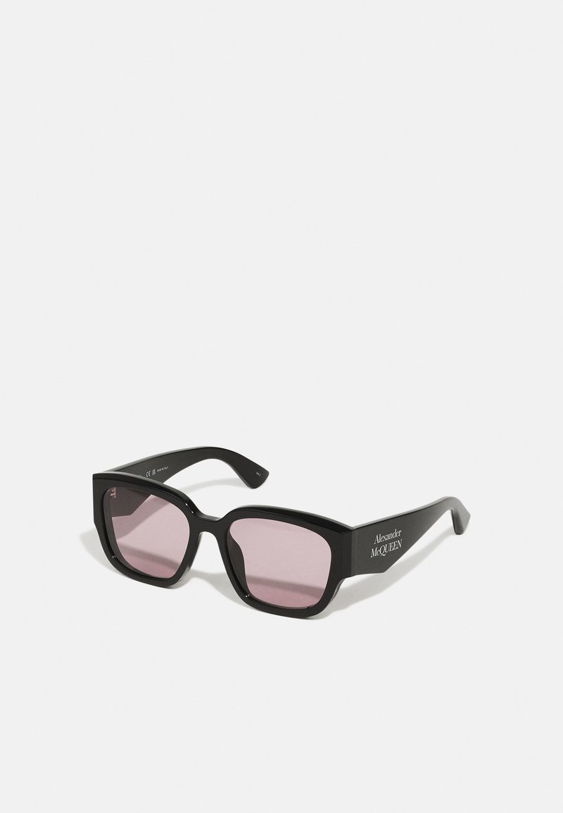 Black rectangular sunglasses with pink lenses, featuring a glossy finish. The arms display "Alexander McQueen" in silver lettering.